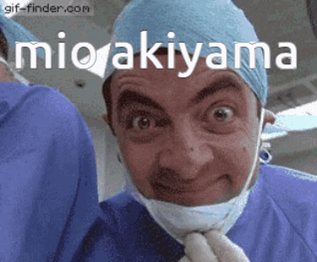 a man wearing a surgical mask and a surgeon 's hat with mio akiyama written on it