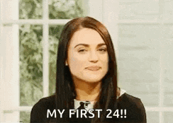 a woman is sitting in front of a window and says `` my first 24 ! ''