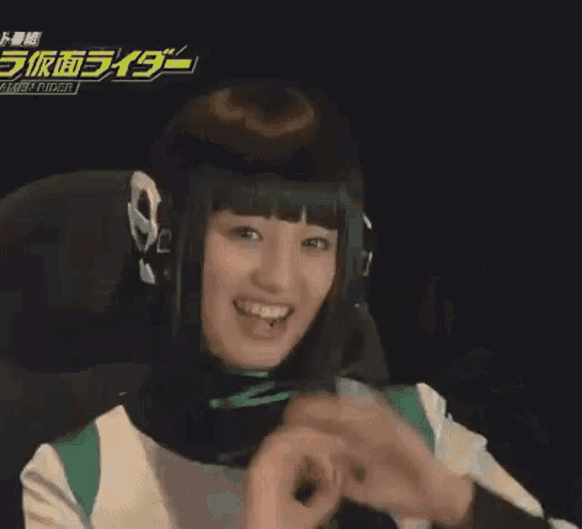 a woman is sitting in a chair with her hands in the air and smiling .