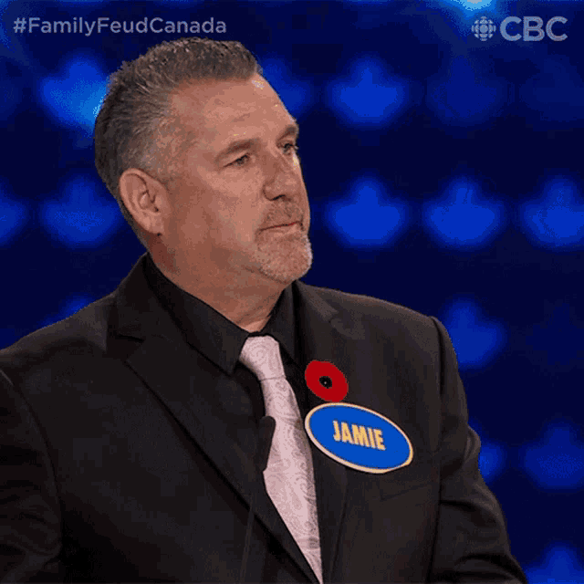 a man in a suit has a name tag that says jamie