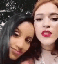 two women are posing for a picture together and one of them has red lips .