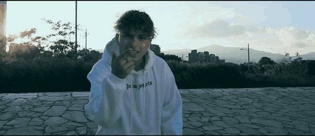 a young man wearing a white hoodie that says " you might fly "