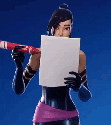 a woman is holding a crayon and a piece of paper in front of her face .