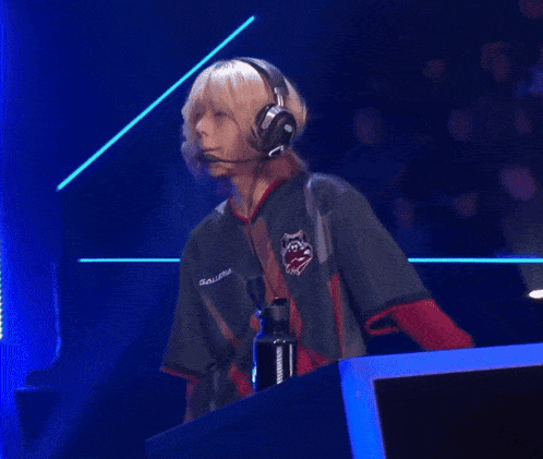 a group of people are playing a video game and one of them is wearing a shirt that says ' e-sports '