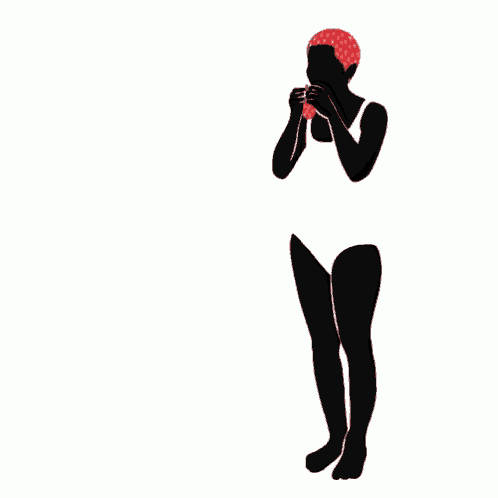 a woman in a bathing suit holds a red cat