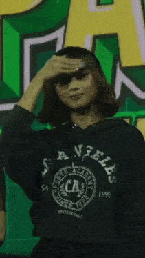 a woman wearing a sports academy ca sweatshirt