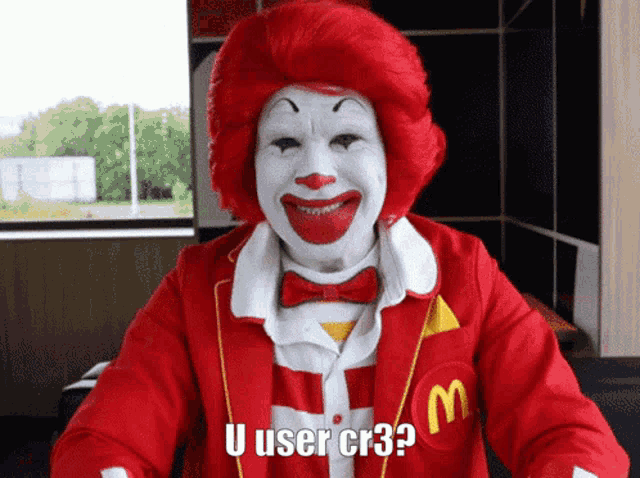 a mcdonald 's clown says u user cr3 while wearing a red jacket
