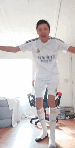 a man wearing a white shirt that says fly emirates on it