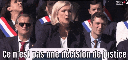 a woman stands in front of a crowd with the words ce n'est pas une decision de justice