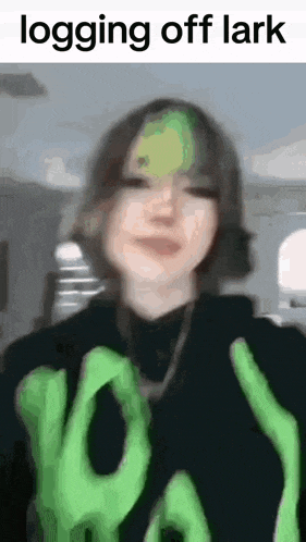 a blurry picture of a girl with green hair and the words `` logging off lark '' .