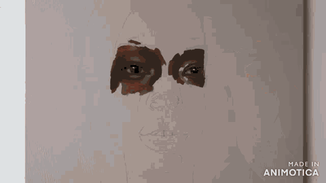 a person is painting a woman 's face with a brush on a canvas .