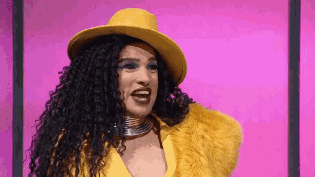 the woman is wearing a yellow hat and a yellow fur coat .