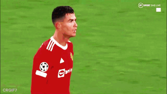 a soccer player in a red jersey is giving a fist bump to another player