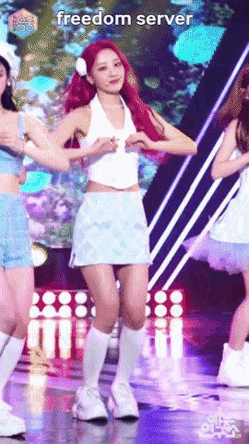 a woman with red hair is dancing on a stage with the words freedom server written on the bottom