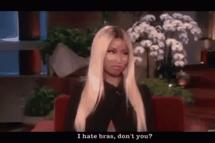 a woman with long blonde hair is sitting in a chair and talking about bras .