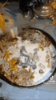 a pan of food with a statue of a man on it .