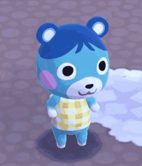 a blue teddy bear with a yellow and white plaid shirt on