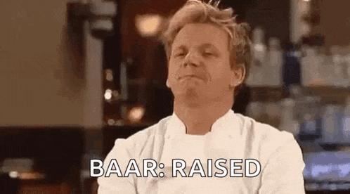 a man in a chef 's uniform is making a funny face and saying baar : raised .