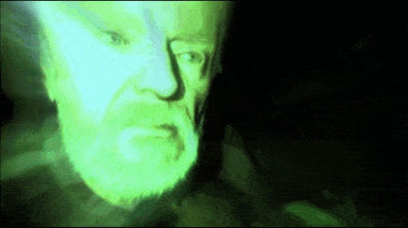 a close up of a man 's face with a green glow
