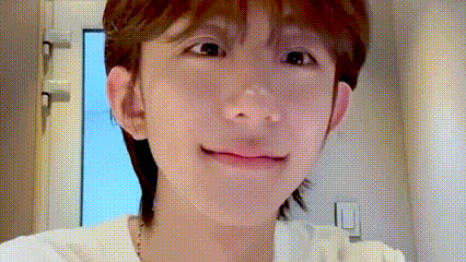 a close up of a person 's face with a blurred background and a window in the background .