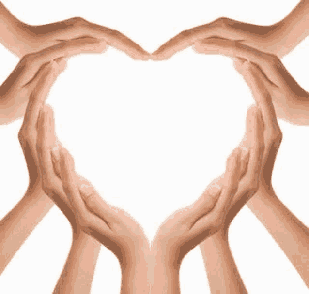 a group of people making a heart shape with their hands .