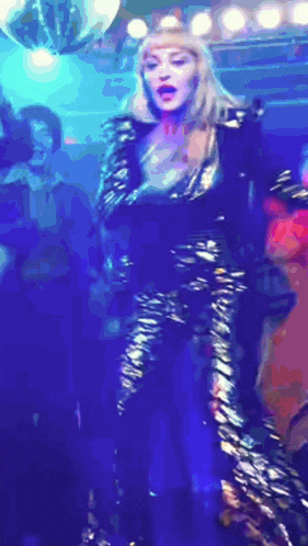 a woman in a zebra print dress is dancing in a club