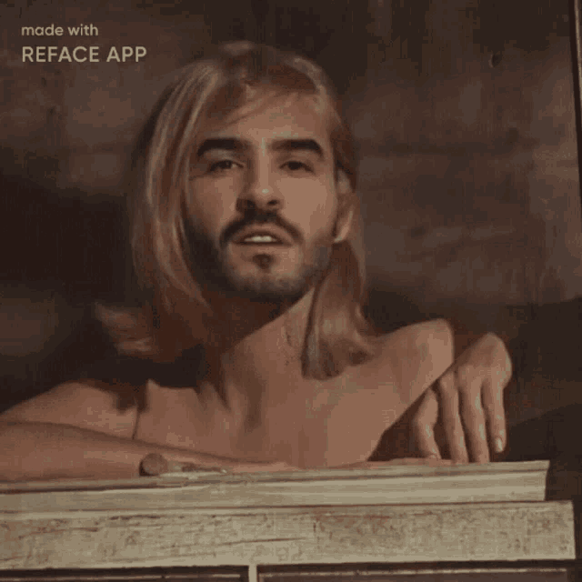 a man with blonde hair and a beard is looking out of a window with the words made with reface app below him