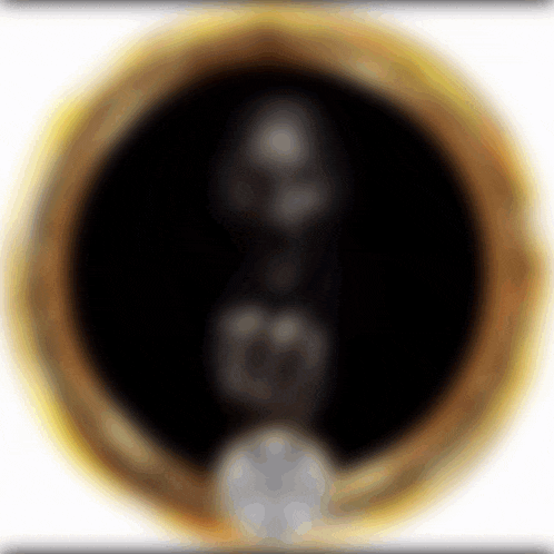 a blurred image of a gold circle with a black center