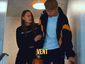 a man holding a fire extinguisher next to a woman with the word vent on the bottom right