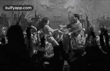a black and white photo of a crowd of people dancing in front of a lion .