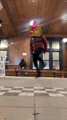 a person is jumping in the air with a pixelated face on their head
