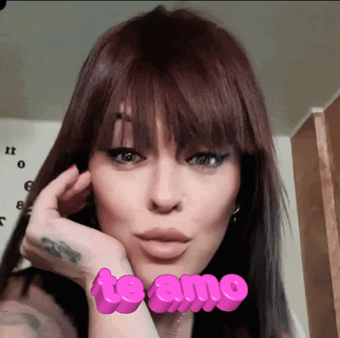 a close up of a woman 's face with the words te amo in pink letters