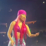 a woman with long pink hair is wearing a pink hat