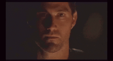 a close up of a man 's face in a dark room