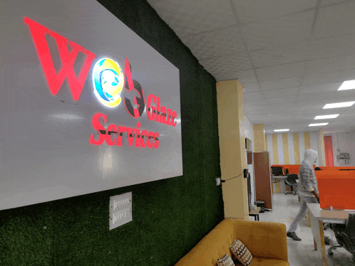 a sign for we glass services hangs on a wall