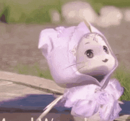 a stuffed animal wearing a purple hat and a purple dress is standing in the grass .