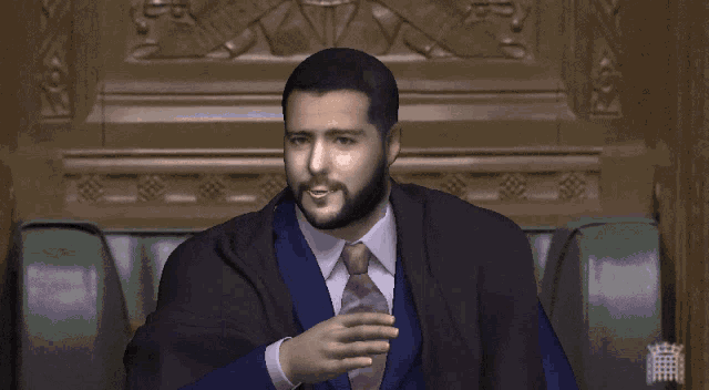 a man in a suit and tie says " not interested " in front of him