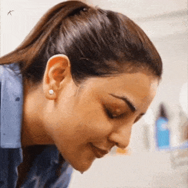 a close up of a woman washing her face in a bathroom