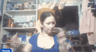 a woman in a blue shirt with the word hoody in the corner