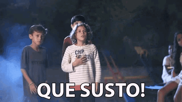 a girl in a shirt that says chp on it stands in front of a group of children and says que susto