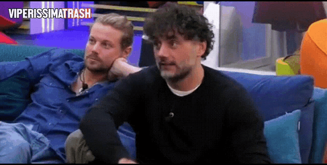 two men are sitting on a couch with the words viperissimotrash written above them