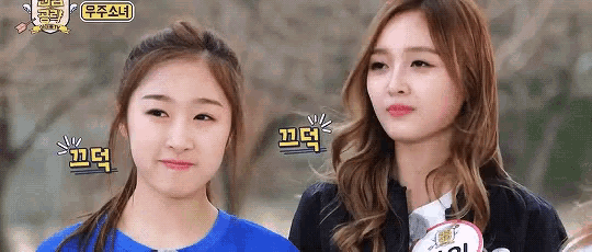two girls are standing next to each other and one of them has a name tag that says ' twice ' on it .