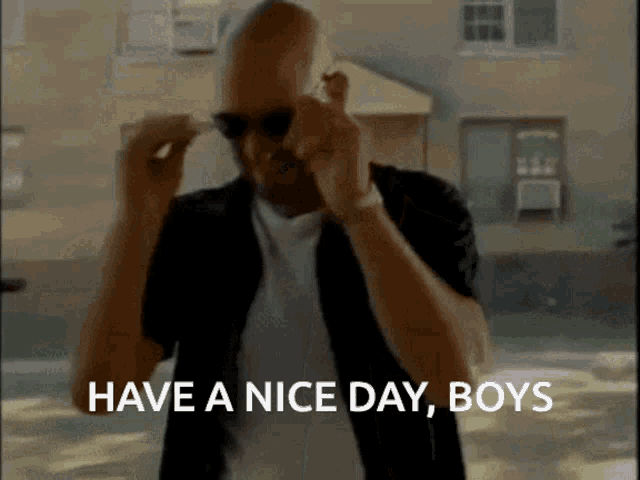 a man wearing sunglasses and a black shirt says " have a nice day boys "