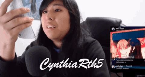 cynthia rith5 is talking into a microphone in front of a screen