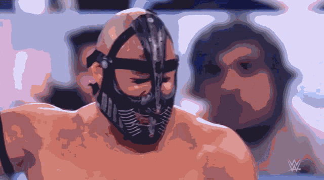 a man wearing a mask with a w logo on the bottom