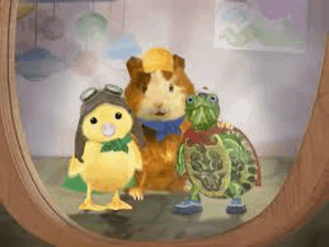 a guinea pig , a duck and a turtle are standing in front of a mirror .