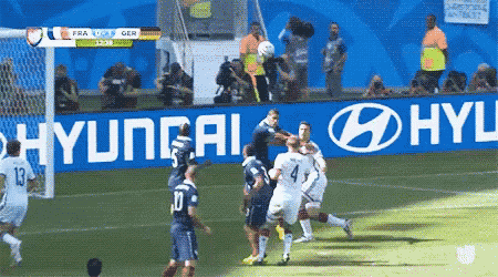 a soccer game is being played on a field with hyundai advertisements in the background