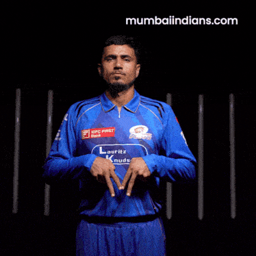 a man wearing a blue shirt with mumbaiindians.com on the bottom
