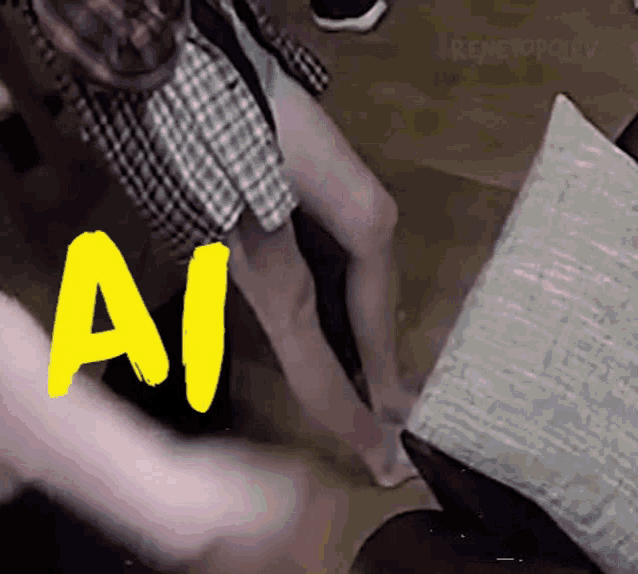 a person standing next to a pillow with the word ai written in yellow