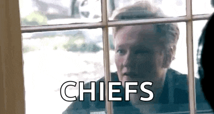 a man is looking out of a window with the word chiefs written on it .